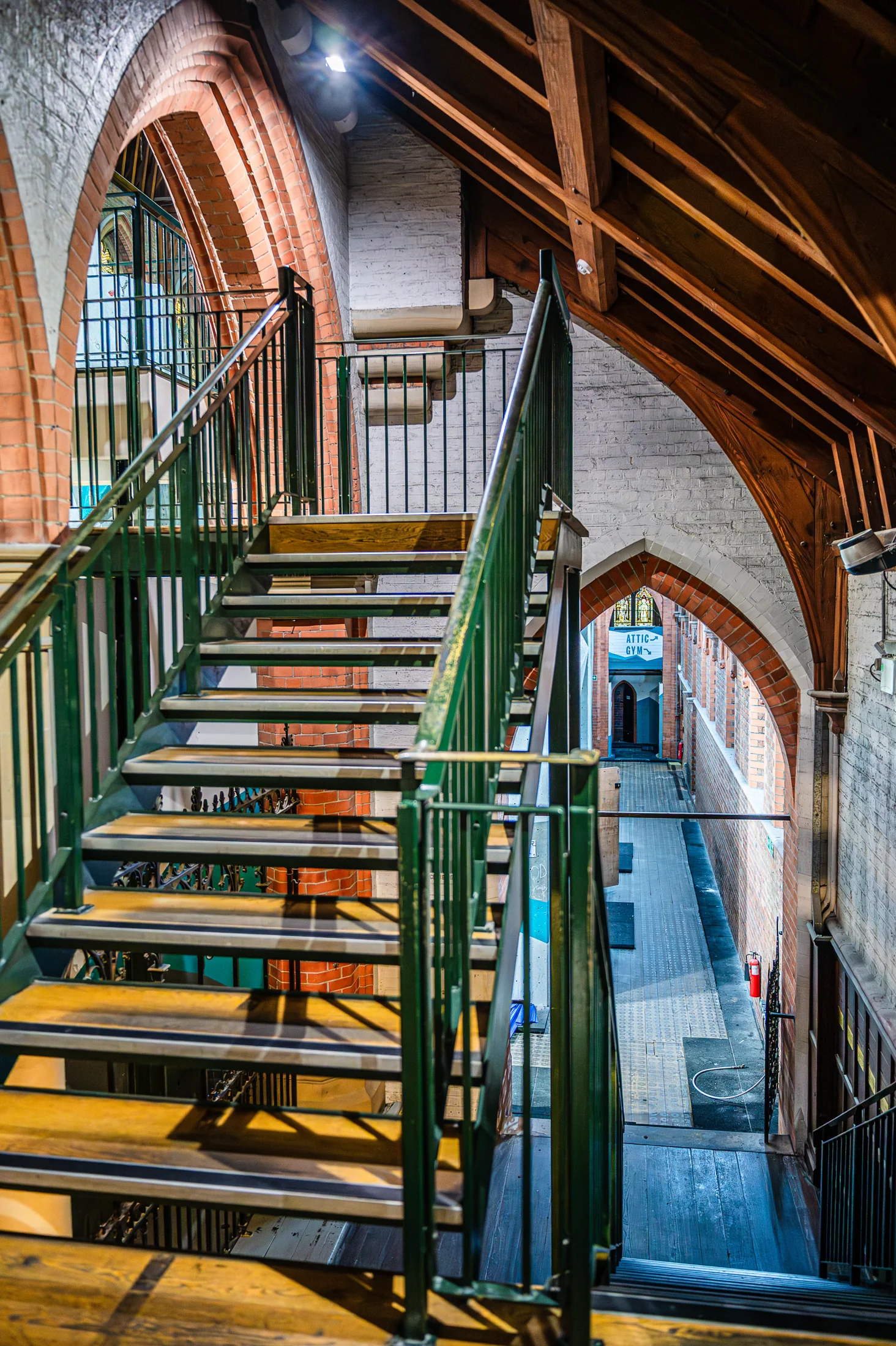 A metal staircase beside brick arches and the former climbing structures